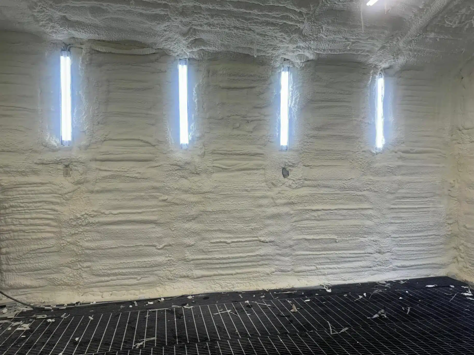How does closed-cell spray foam add structural strength to home walls?